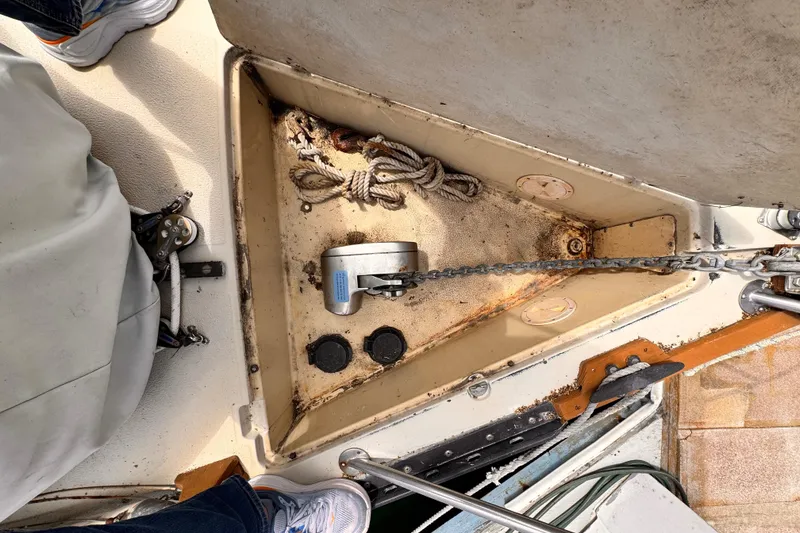 Anchor locker of a 1978 Islander 36 sailboat with chain and rope.
