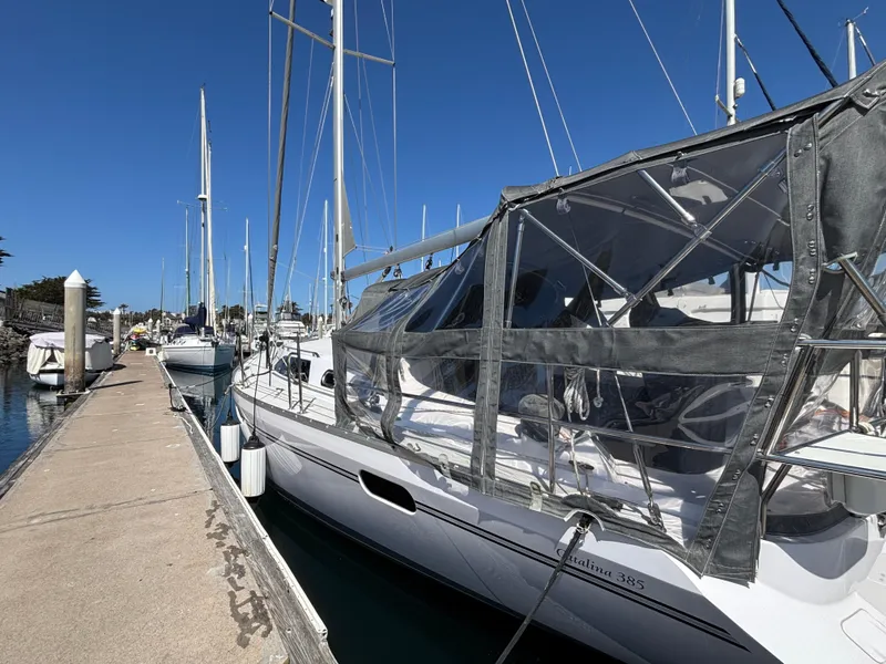 2019 Catalina 385 sailboat docked at marina under clear blue sky.