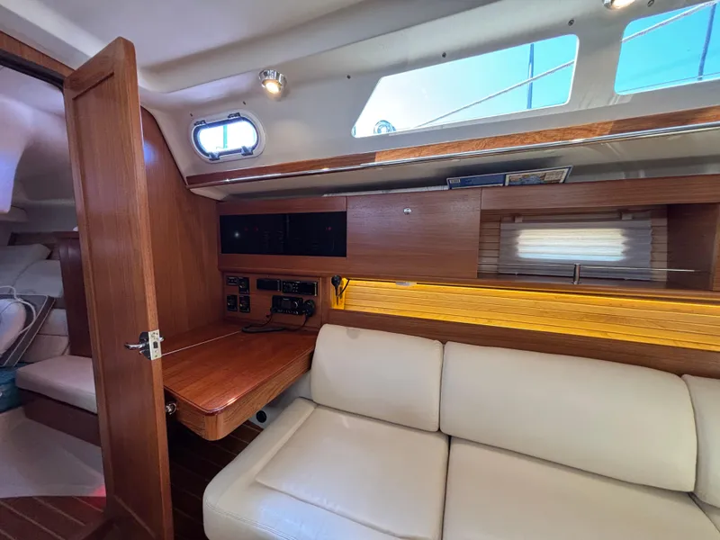 Interior of 2019 Catalina 385 sailboat with wooden accents and comfortable seating.