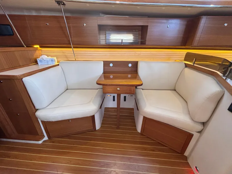 Interior of 2019 Catalina 385 yacht with cozy seating and wooden accents.