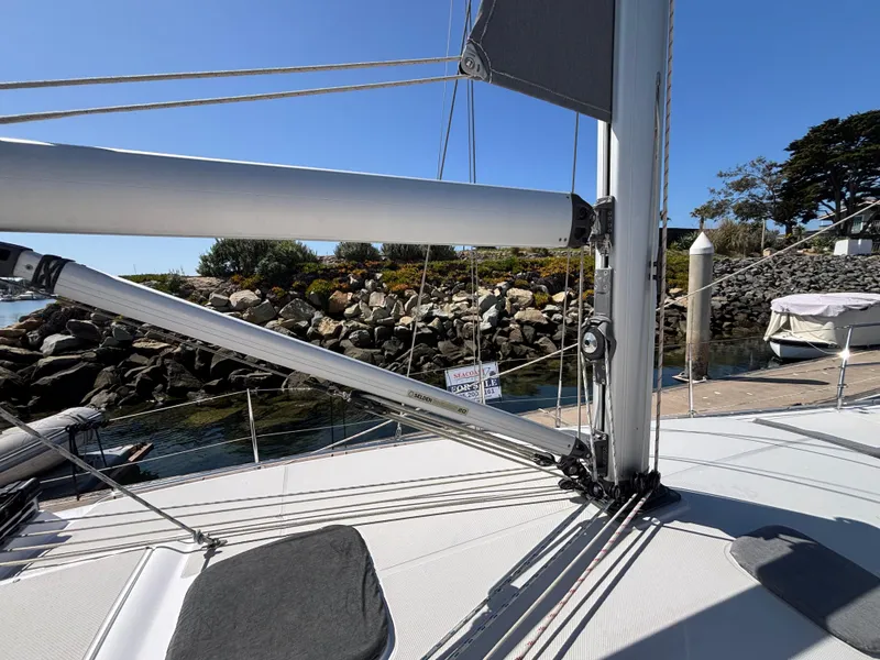 Sailboat deck view of 2019 Catalina 385, docked near rocky shoreline.