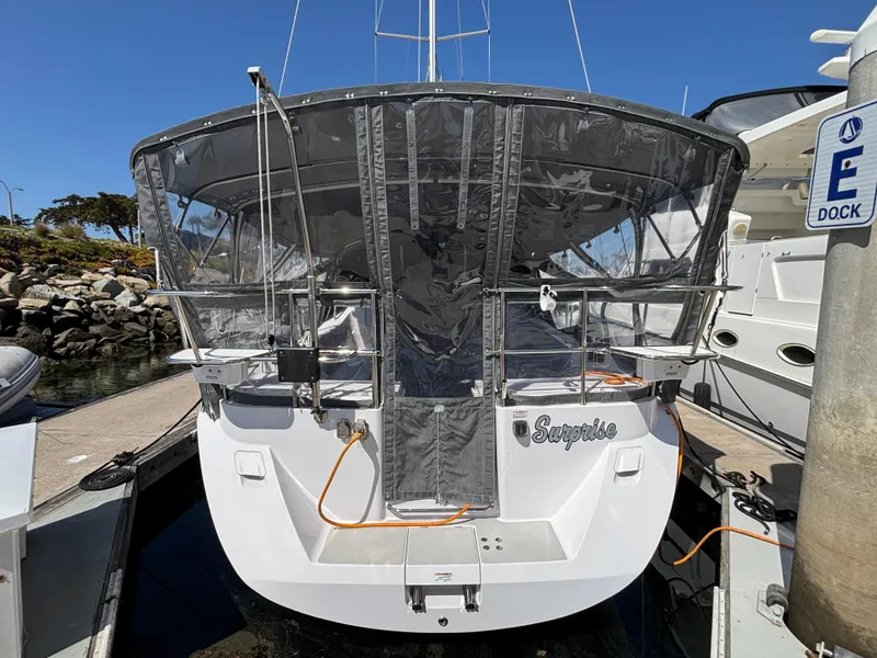 2019 Catalina 385 sailboat docked, featuring a covered cockpit and visible marina surroundings.