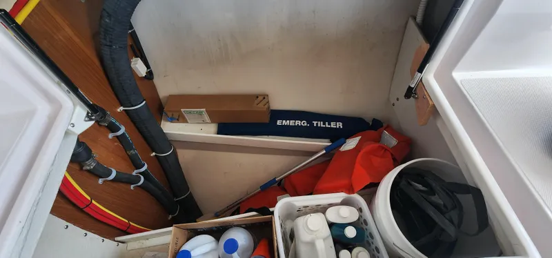 Storage compartment in a 2019 Catalina 385 sailboat with emergency tiller and supplies.