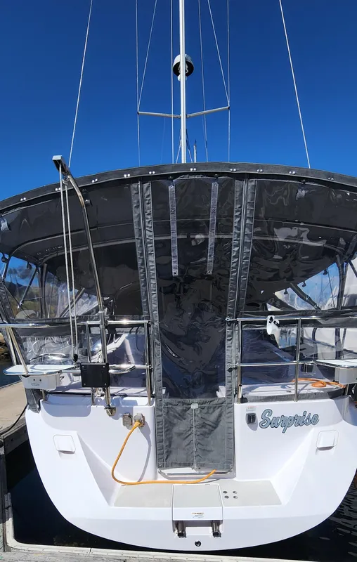 2019 Catalina 385 sailboat docked, rear view with canopy and clear skies.