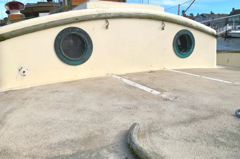 1980 Tayana Pilot House boat deck with round windows, docked in a marina.