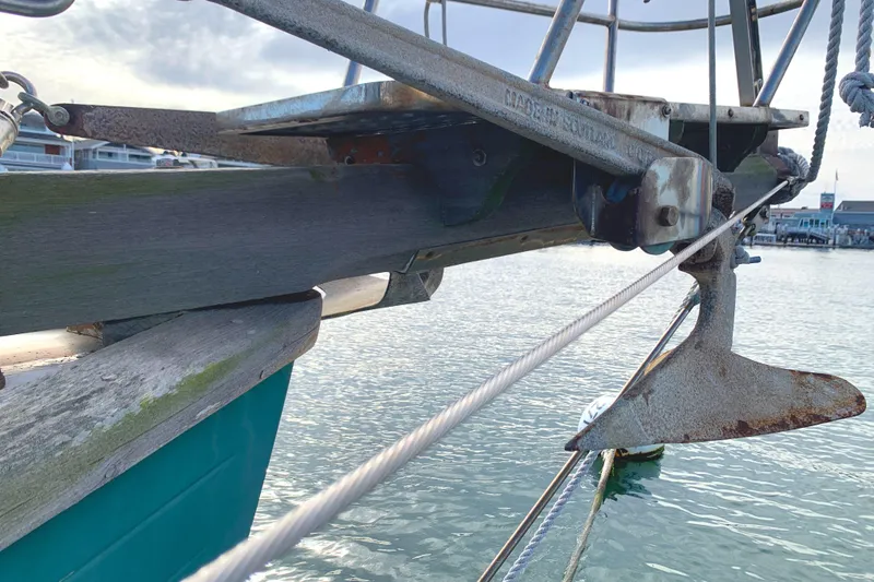 Anchor on 1980 Tayana Pilot House sailboat in marina setting.