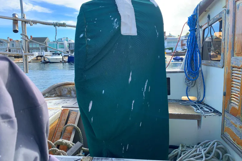 1980 Tayana Pilot House sailboat deck with covered equipment and marina view.