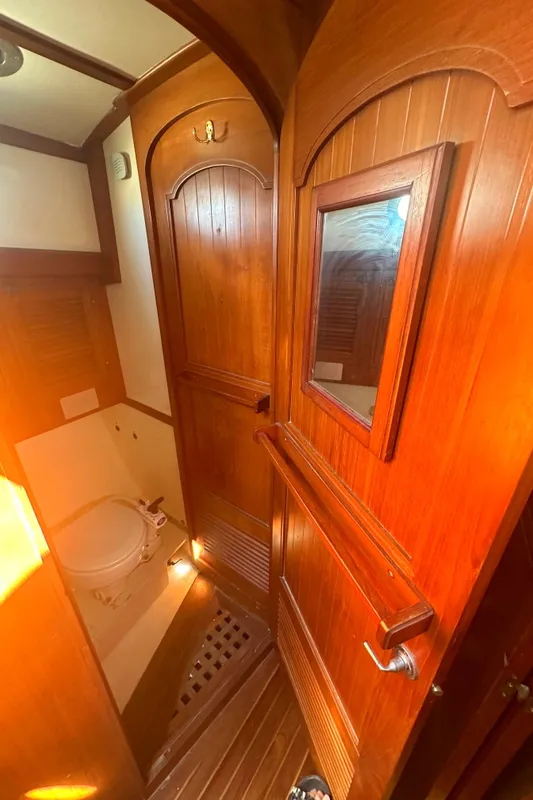 1980 Tayana Pilot House bathroom with wooden interior and compact design.