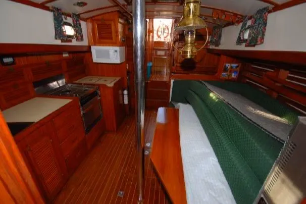 Interior of 1980 Tayana Pilot House yacht with wood finish and cozy living space.