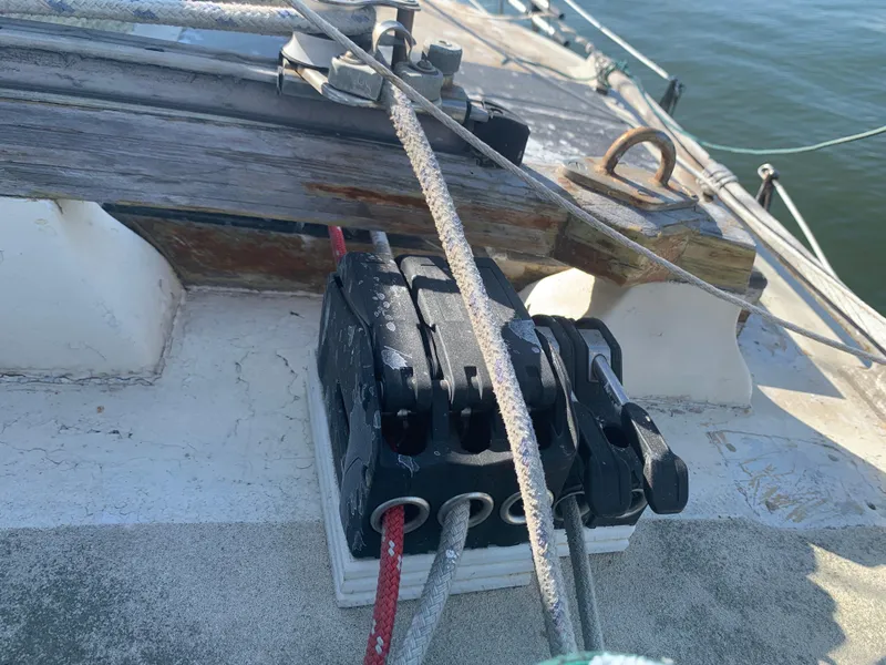 Deck hardware on 1980 Tayana Pilot House sailboat with ropes and cleats.