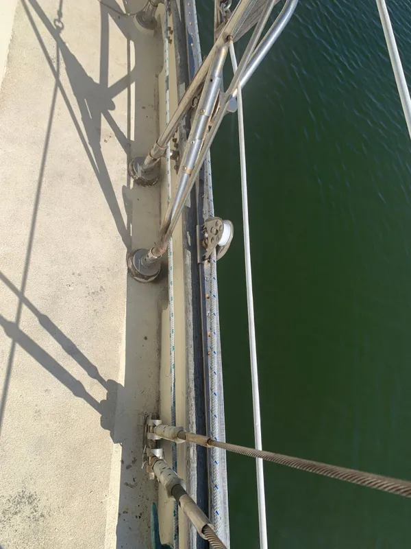 Deck view of 1980 Tayana Pilot House sailboat with rigging and green water.