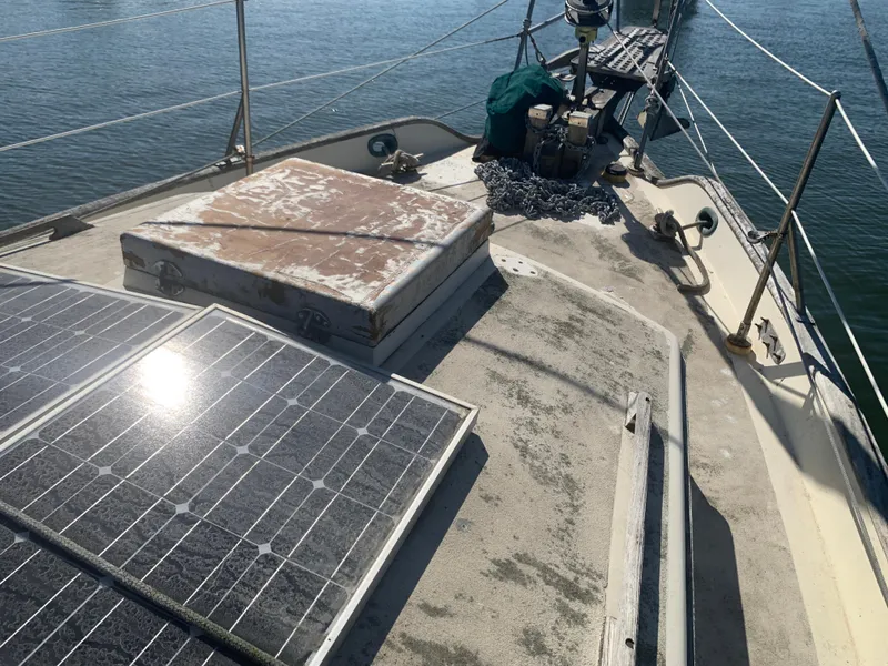 1980 Tayana Pilot House sailboat deck with solar panels and nautical equipment.