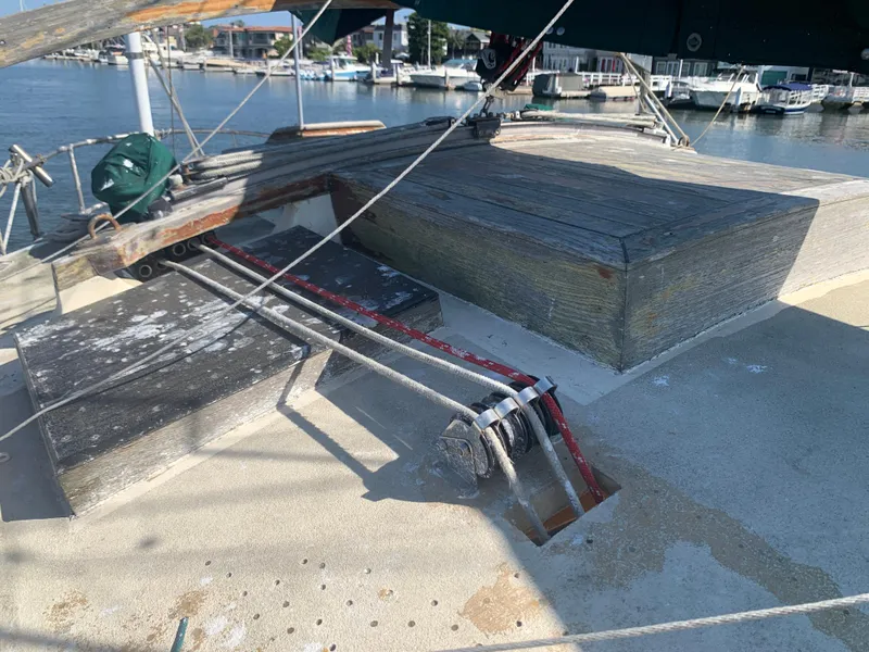 1980 Tayana Pilot House sailboat deck with rigging and marina background.