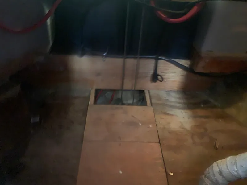 Interior view of 1980 Tayana Pilot House with wooden flooring and visible wiring.