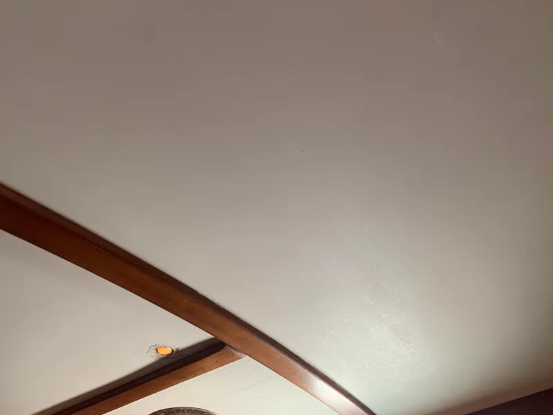 Interior ceiling of 1980 Tayana Pilot House with wooden beams and lighting.