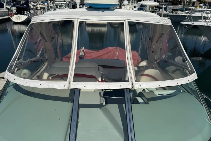 2003 Formula 37 Performance Cruiser at marina, featuring enclosed cockpit and clear canopy.