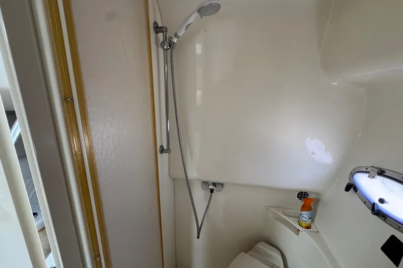 Bathroom interior of a 2003 Formula 37 Performance Cruiser with shower and porthole.
