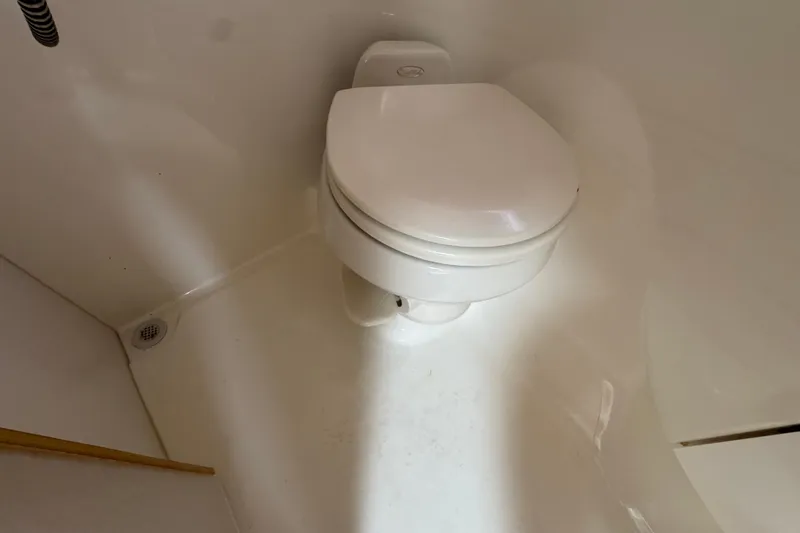 2003 Formula 37 Performance Cruiser bathroom with white marine toilet.