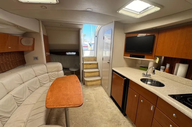 Interior of 2003 Formula 37 Performance Cruiser with kitchen, seating, and stairs to deck.