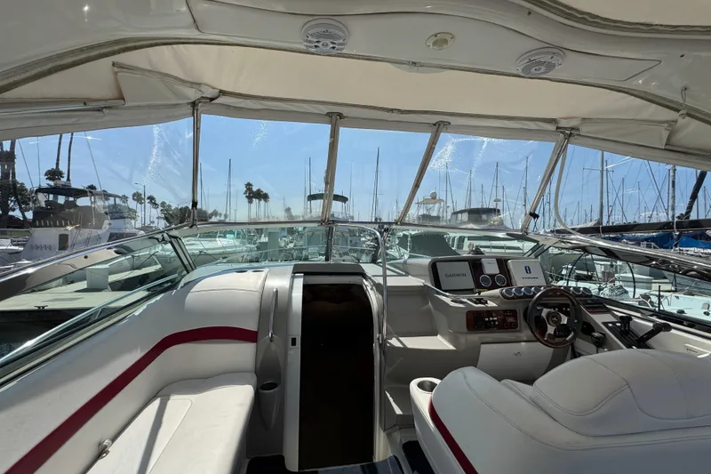 2003 Formula 37 Performance Cruiser cockpit with marina view, featuring navigation equipment and seating.
