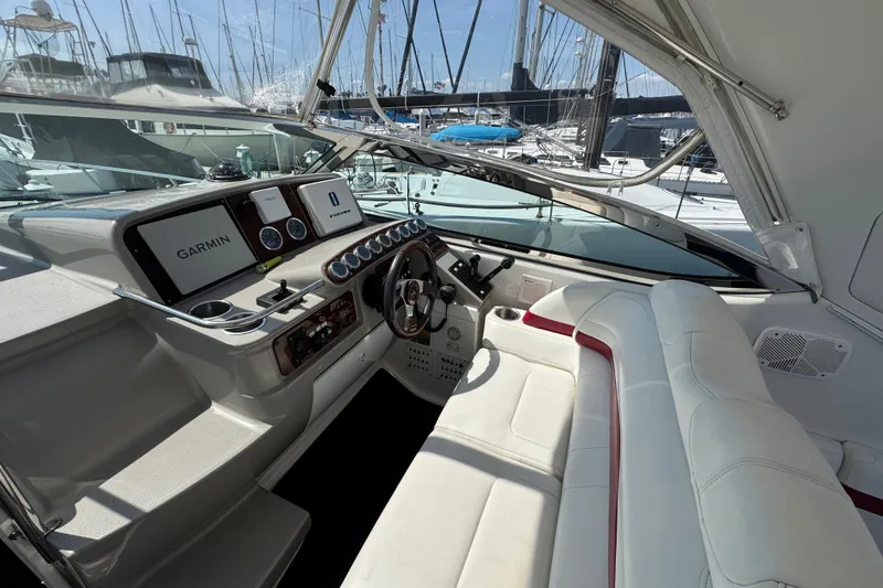 2003 Formula 37 Performance Cruiser cockpit with Garmin navigation, white seating, and marina view.