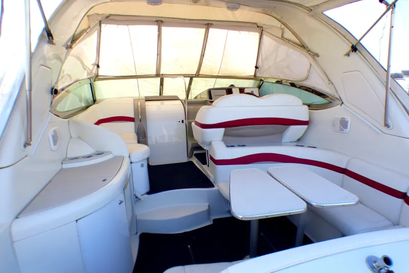 2003 Formula 37 PC yacht interior with white and red seating, dining area, and helm.