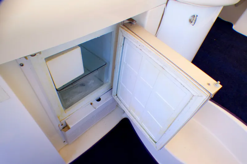 Open mini fridge in 2003 Formula 37 PC boat interior.