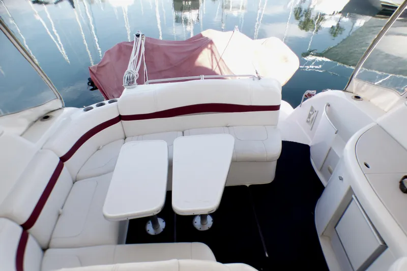 2003 Formula 37 PC yacht interior with white seating and tables, docked on calm water.