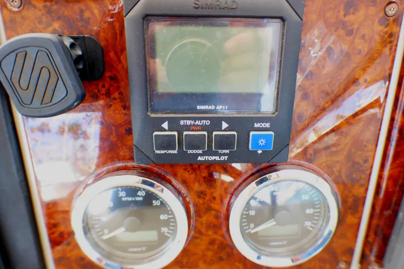 Control panel of a 2003 Formula 37 PC boat with gauges and autopilot system.