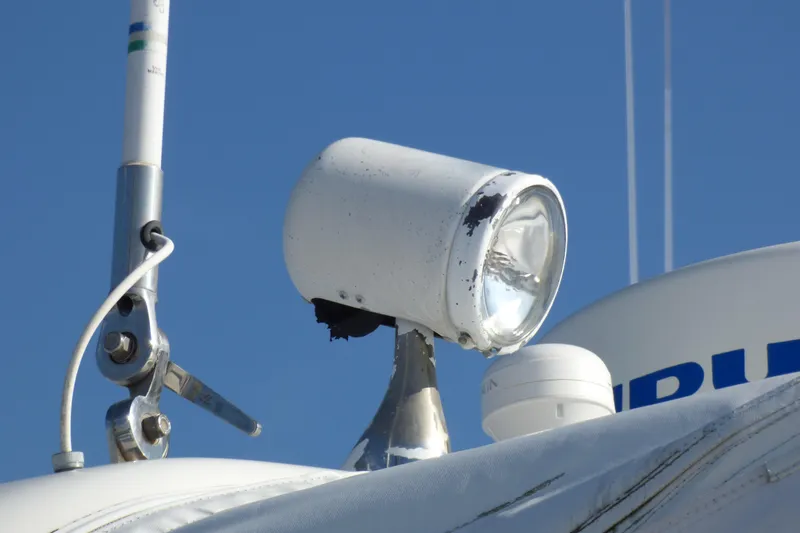 2003 Formula 37 PC boat spotlight and antenna against clear blue sky.