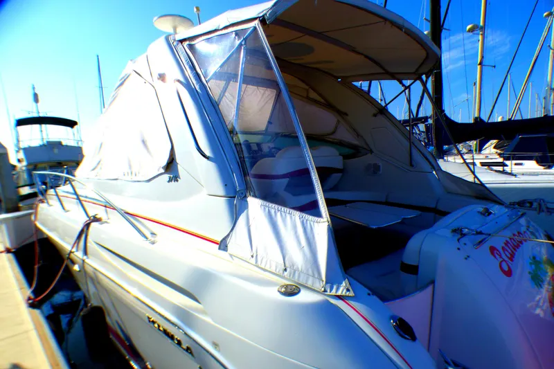 2003 Formula 37 PC yacht docked at marina with covered cockpit and clear blue sky.