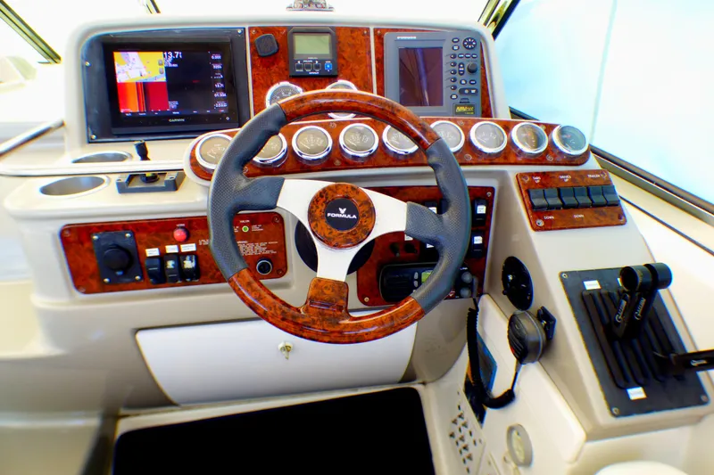 2003 Formula 37 PC boat dashboard with wood accents and modern controls.