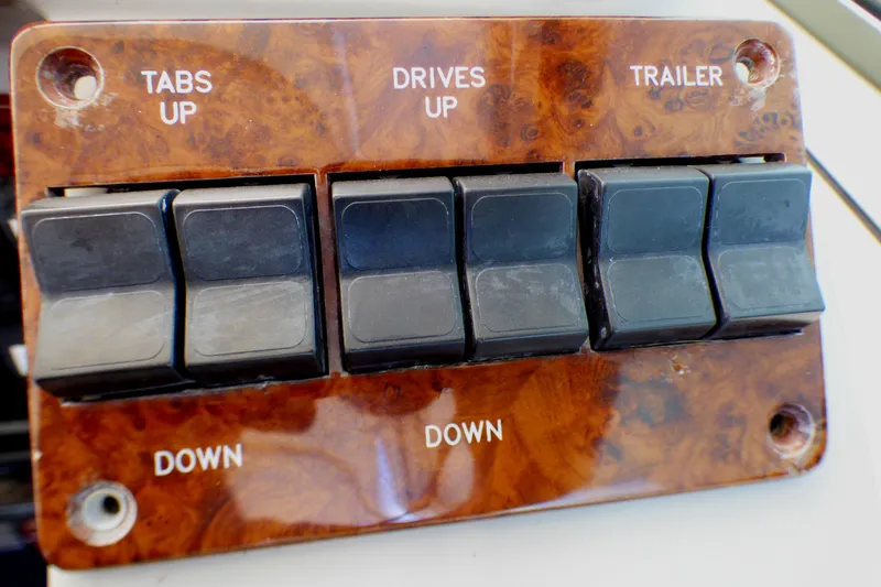 Control panel with switches for tabs, drives, and trailer on a 2003 Formula 37 PC boat.