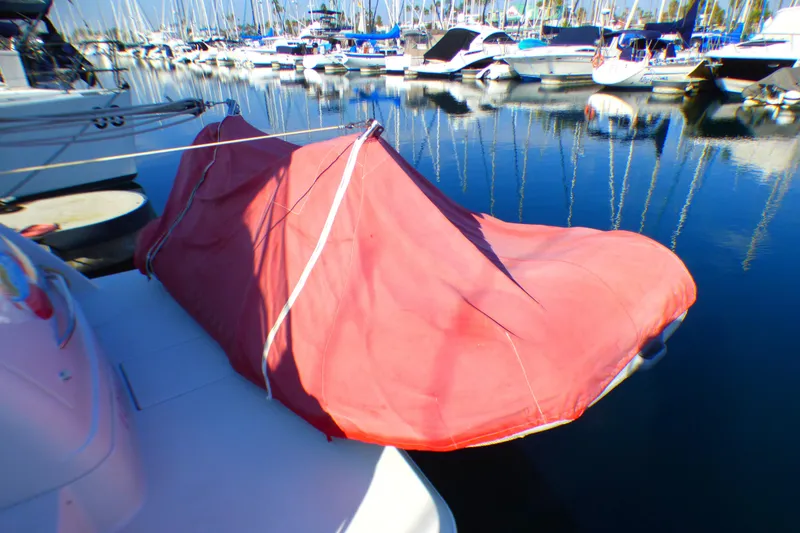2003 Formula 37 PC boat with red cover docked in marina.