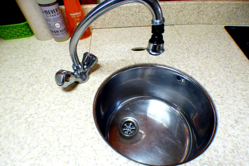 Stainless steel sink with faucet on a Formula 37 PC 2003 boat.