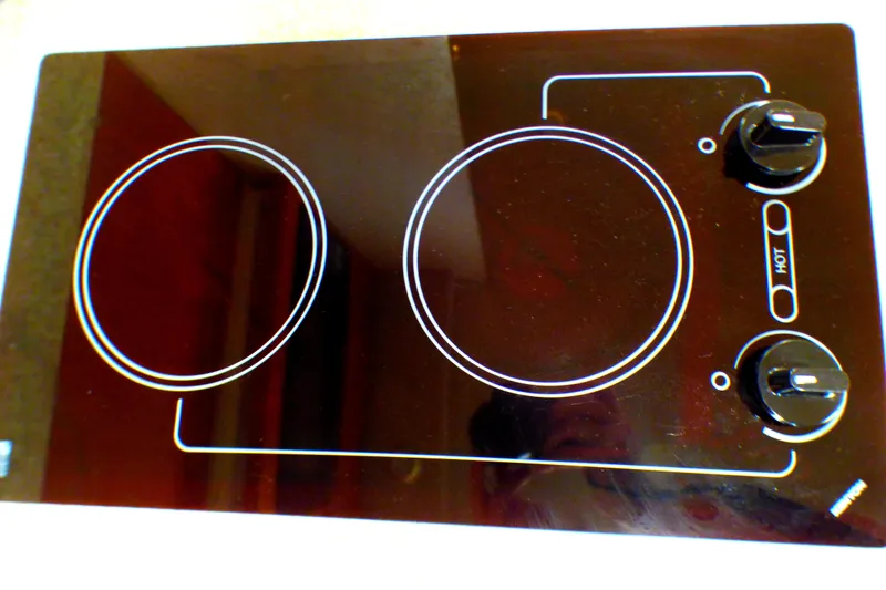 Ceramic cooktop with two burners and control knobs, part of a 2003 Formula 37 PC.