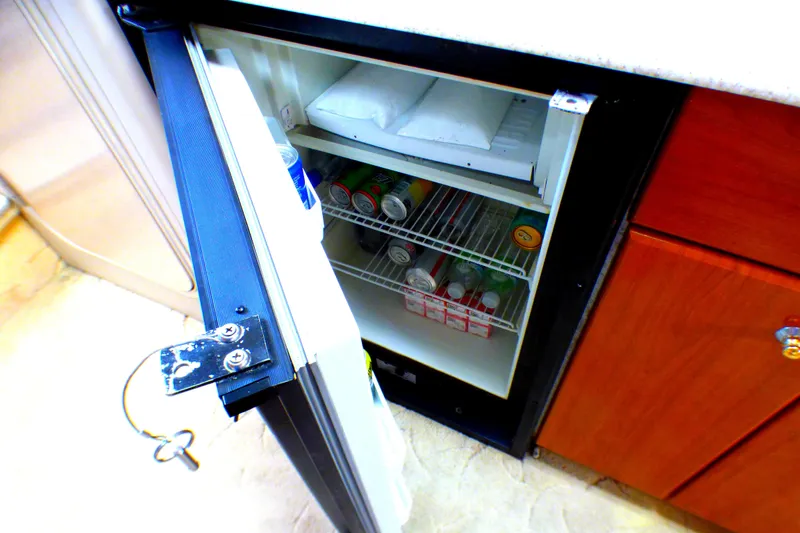 Mini fridge in 2003 Formula 37 PC yacht, stocked with beverages and ice packs.