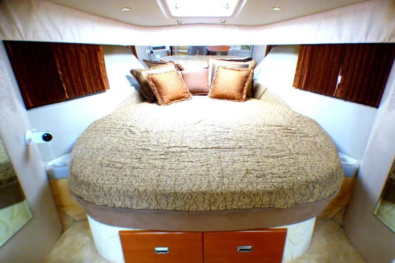 Luxurious bedroom interior of 2003 Formula 37 PC yacht with plush bedding and cushions.