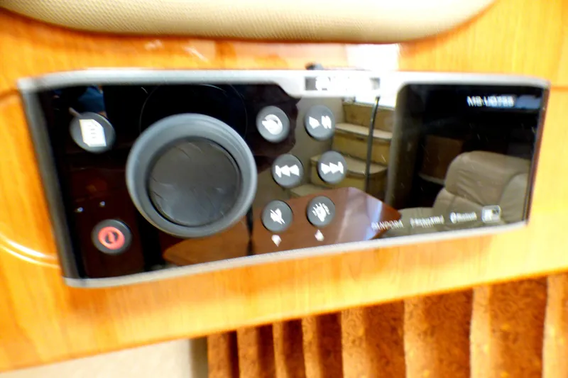 Control panel of a 2003 Formula 37 PC boat with various buttons and a dial.