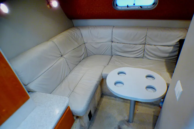 2003 Formula 37 PC interior with beige leather seating and round table.