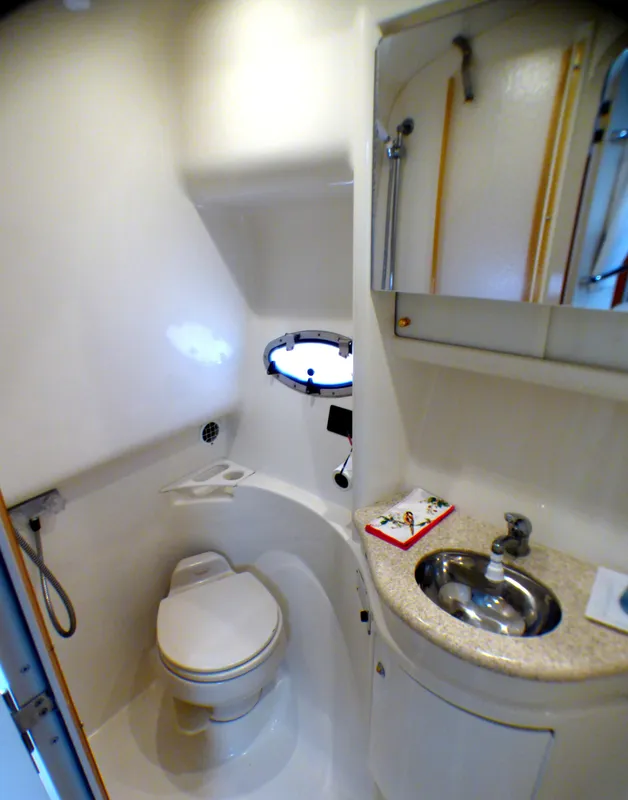 2003 Formula 37 PC yacht bathroom with toilet, sink, and mirror.