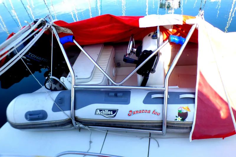 2003 Formula 37 PC boat with red cover and inflatable dinghy on deck.