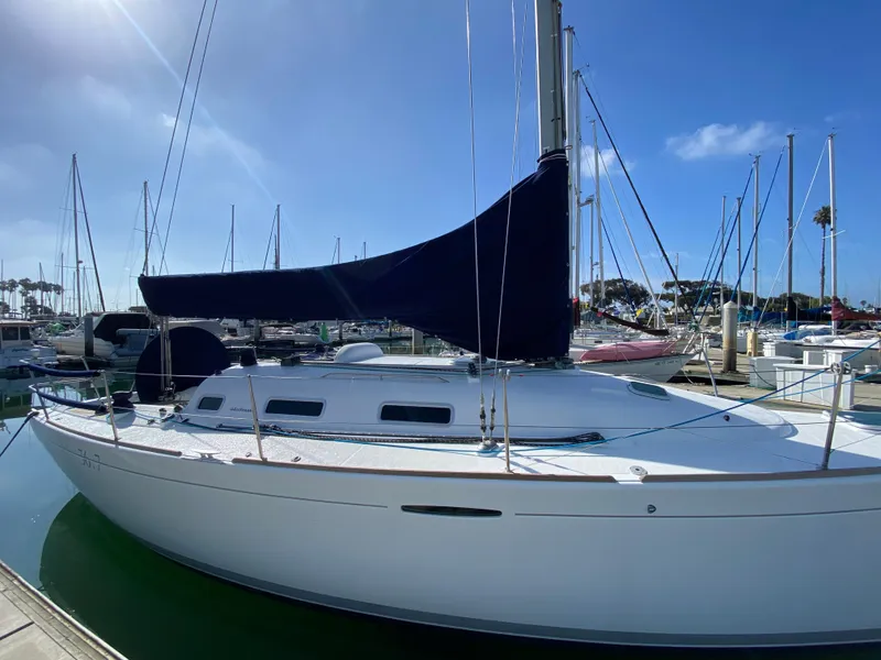 2004 Beneteau 36.7 sailboat docked at marina under clear blue sky.