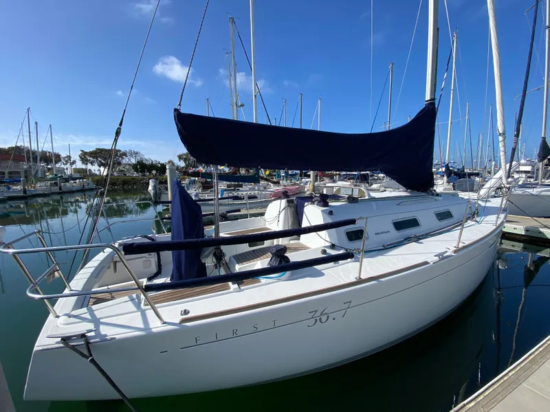 2004 Beneteau 36.7 sailboat docked in a marina on a sunny day.