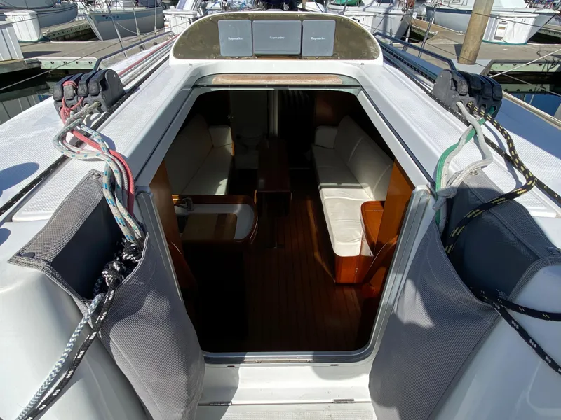 2004 Beneteau 36.7 sailboat interior view with seating and table.