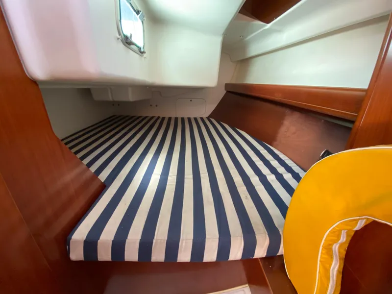 Beneteau 36.7 2004 sailboat interior cabin with striped mattress.