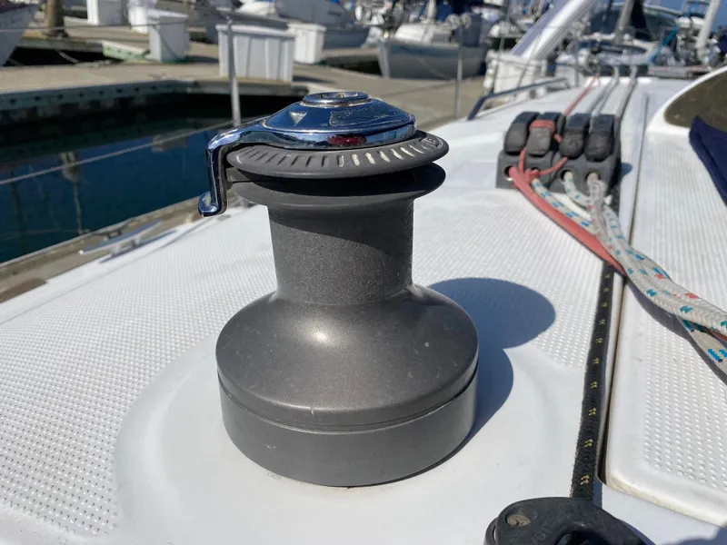 Winch on deck of 2004 Beneteau 36.7 sailboat in marina.