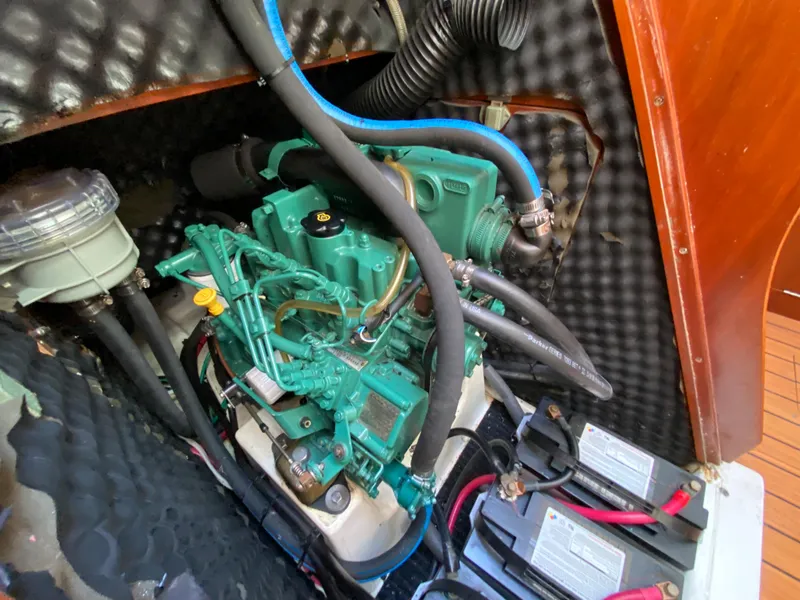 Engine compartment of a 2004 Beneteau 36.7 sailboat with visible engine and batteries.