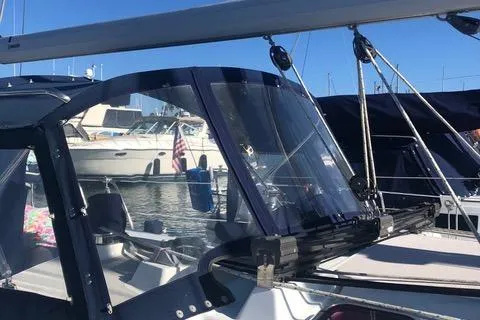2008 Catalina 320 MkII sailboat docked in marina, featuring clear cockpit enclosure.