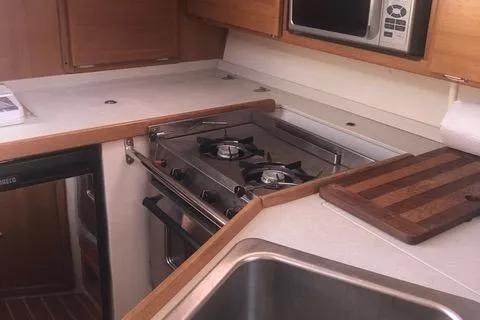 2008 Catalina 320 MkII yacht kitchen with stove, sink, and microwave.